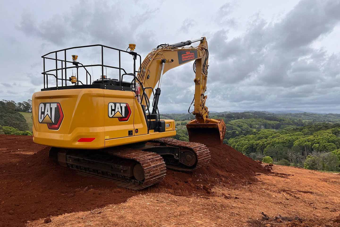 CAT 323 playing in the red dirt